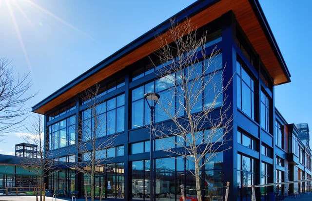 exterior-of-cambridge-crossing-featuring-floor-to-ceiling-curtain-wall-glazing-and-dark-aluminum-framing-with-a-wood-soffit-roofline